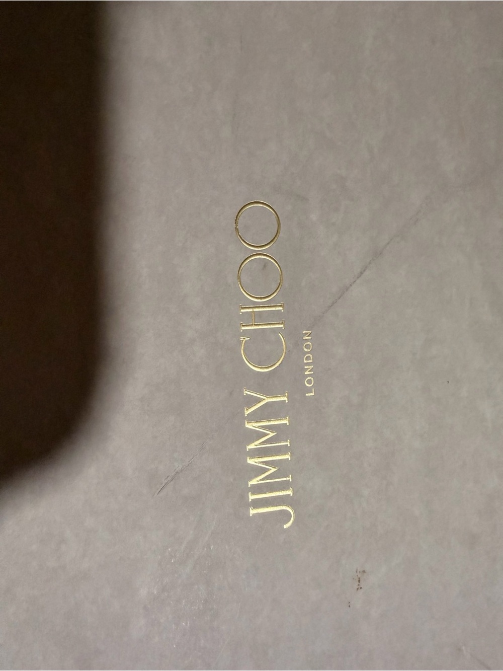 Jimmy Choo Gold Logo on Gray Box